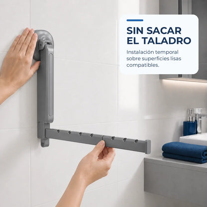 Instalación temporal del tendedero plegable gris sobre una superficie lisa sin perforar